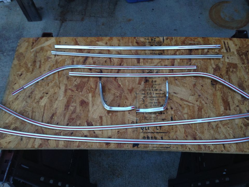 Chrome and red pinstripe trim pieces on plywood