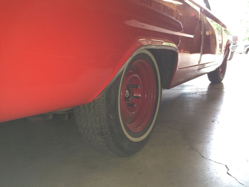 Red classic car rear passenger side wheel and fender well