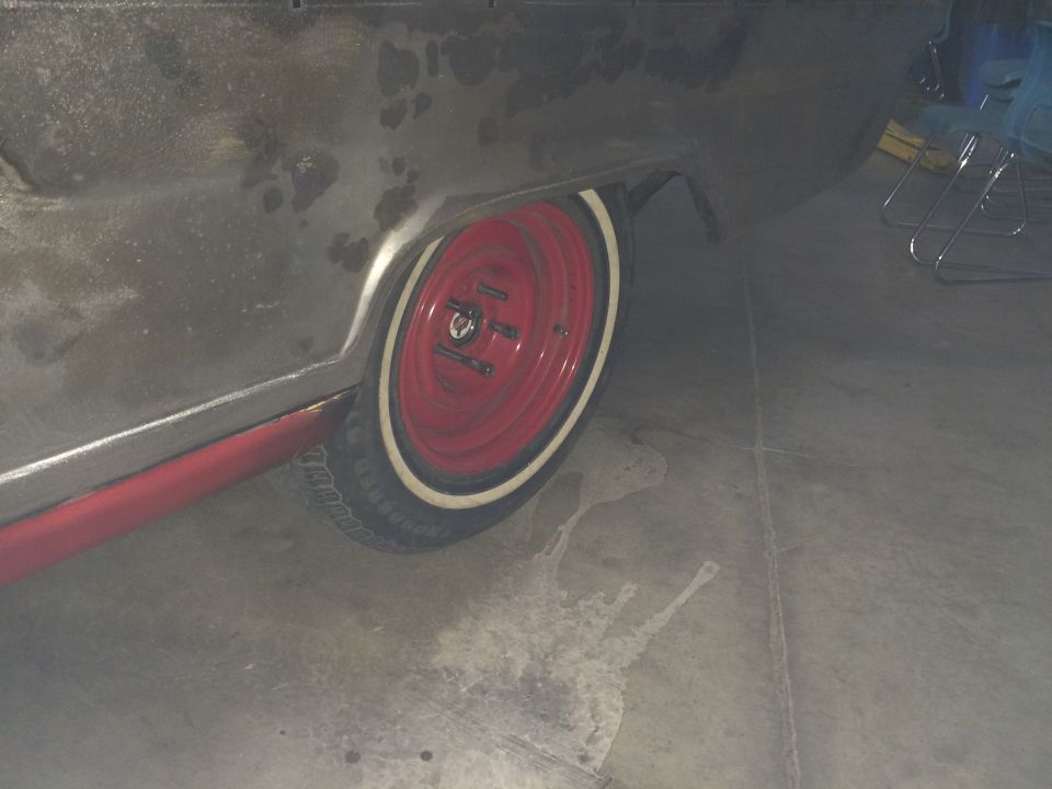 1964 Ford Fairlane rear quarter panel and red wheel with whitewall tire