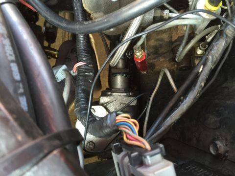 1965 Ford Mustang - Close-up view of engine bay wiring and mechanical parts, no specific vehicle identified.