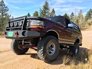 1996 Ford Bronco - This modified Ford Bronco is equipped for off-road adventures with its heavy-duty bumper and lifted suspension.