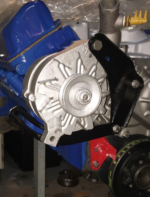 1978 Ford Bronco - Engine parts including an alternator and valve covers are shown in this close-up view.