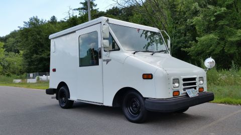 1991 Ford Crown Victoria LTD - This Grumman LLV postal vehicle is seen from the front-right in an outdoor setting.