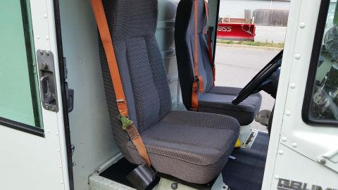 1991 Ford LTD Crown Victoria - The interior of a utility vehicle, two seats and a steering wheel, is visible from the side.
