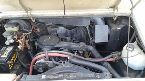 1991 Ford LTD Crown Victoria - The engine bay of a vehicle, showing the V8 engine and various fluid reservoirs.