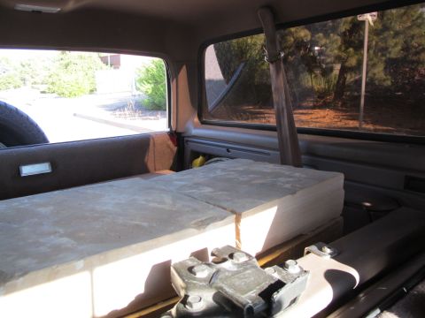 1996 Ford Bronco - The interior of a vehicle is shown, loaded with cargo and a spare tire. The view looks towards the rear of the vehicle.