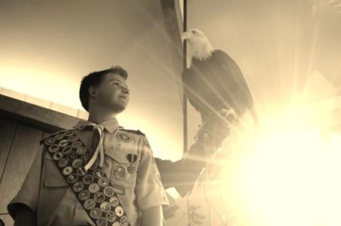 1996 Ford Bronco - A young boy scout stands with a bald eagle, bathed in bright sunlight.