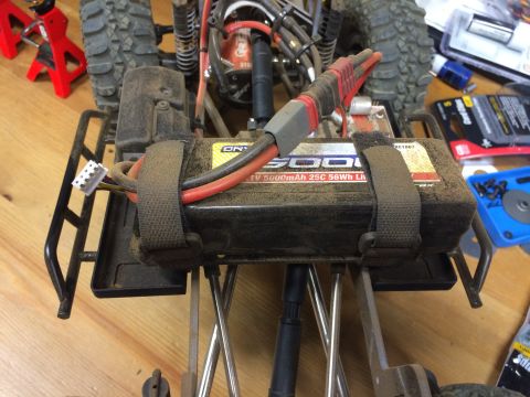 1989 Ford Bronco - The underside of a remote control car chassis shows a battery pack and wiring, with no visible year identification.