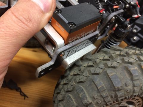 1989 Ford Bronco - Close-up of a hobby-grade RC car's servo and tire assembly.