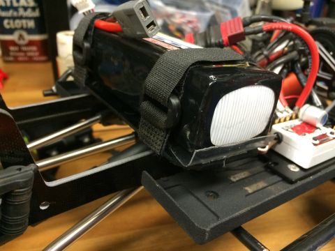 1989 Ford Bronco - Close-up of a battery pack and wiring on a remote-controlled vehicle chassis.