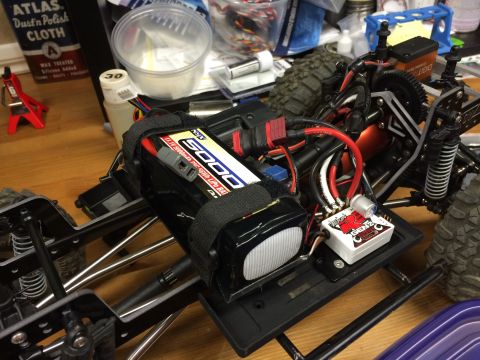 1989 Ford Bronco - Close-up view of an RC car's internal components, including a large battery pack and electronic speed controller.