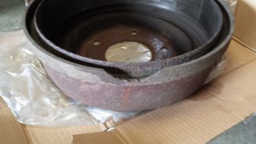 1996 Ford Bronco - A close-up view of a damaged brake drum, indicating wear and tear.
