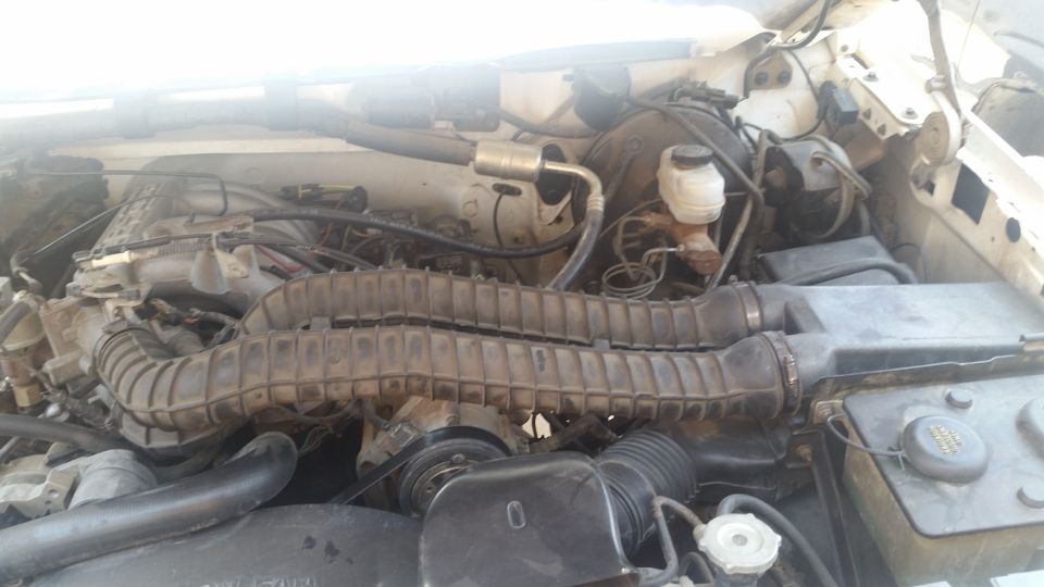 engine bay with air intake tubes and brake fluid reservoir