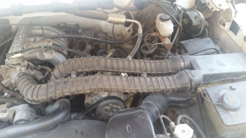 1992 Ford Bronco - Close-up view of an engine bay, focusing on the air intake system and brake components.