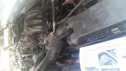 1992 Ford Bronco - Installation instructions for K&N Stage II Air Intake are laid out near engine components.