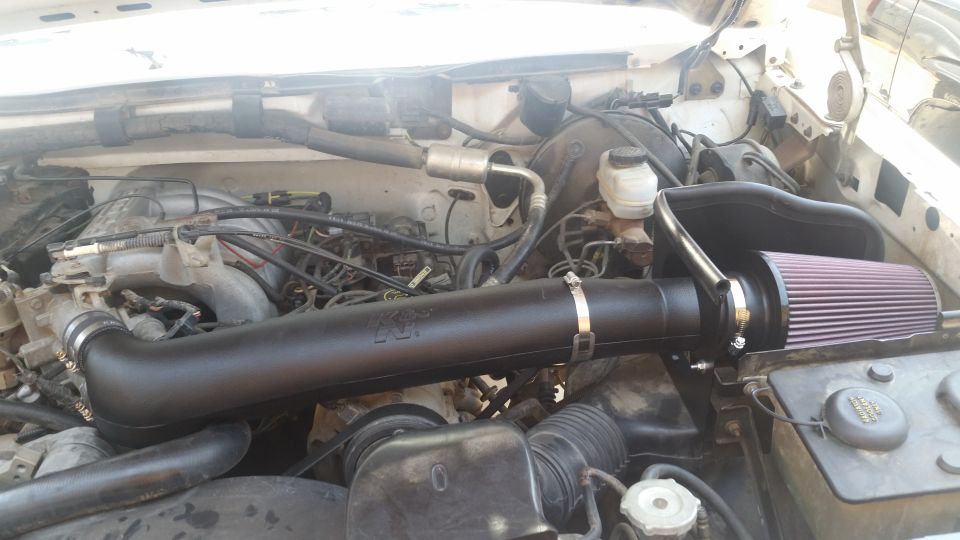 1992 Ford Bronco engine bay with K&N cold air intake and red cone filter.