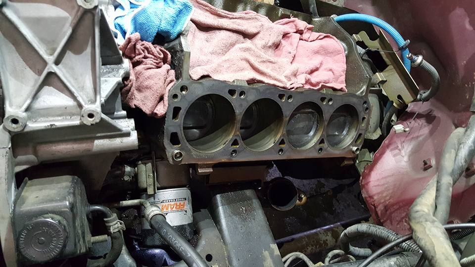 Engine block with cylinders exposed, oil filter visible