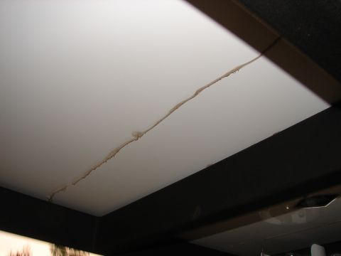 1973 Ford Ranchero - Damage to the ceiling of a trailer interior, showing a crack and staining.