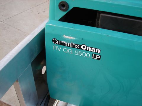 1973 Ford Ranchero - Close-up of a teal generator unit displaying the Cummins Onan RV QG 5500 LP model information.