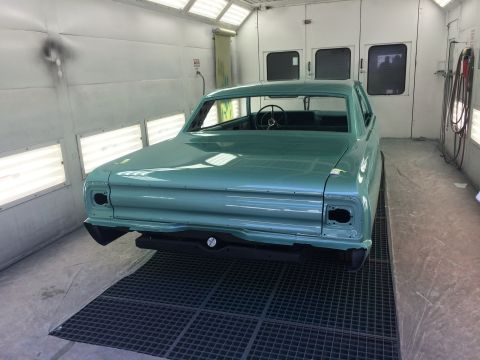 1964 Ford Fairlane - A teal 1964 Ford Fairlane is positioned in a paint booth, ready for its next coat of paint.