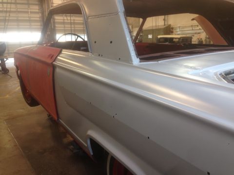 1964 Ford Fairlane - 1964 Ford Fairlane undergoing bodywork, showing primer and a red front fender.