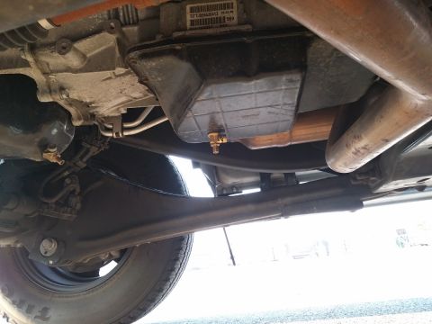 2000 Ford Crown Victoria - Underside view shows transmission pan and exhaust system components.