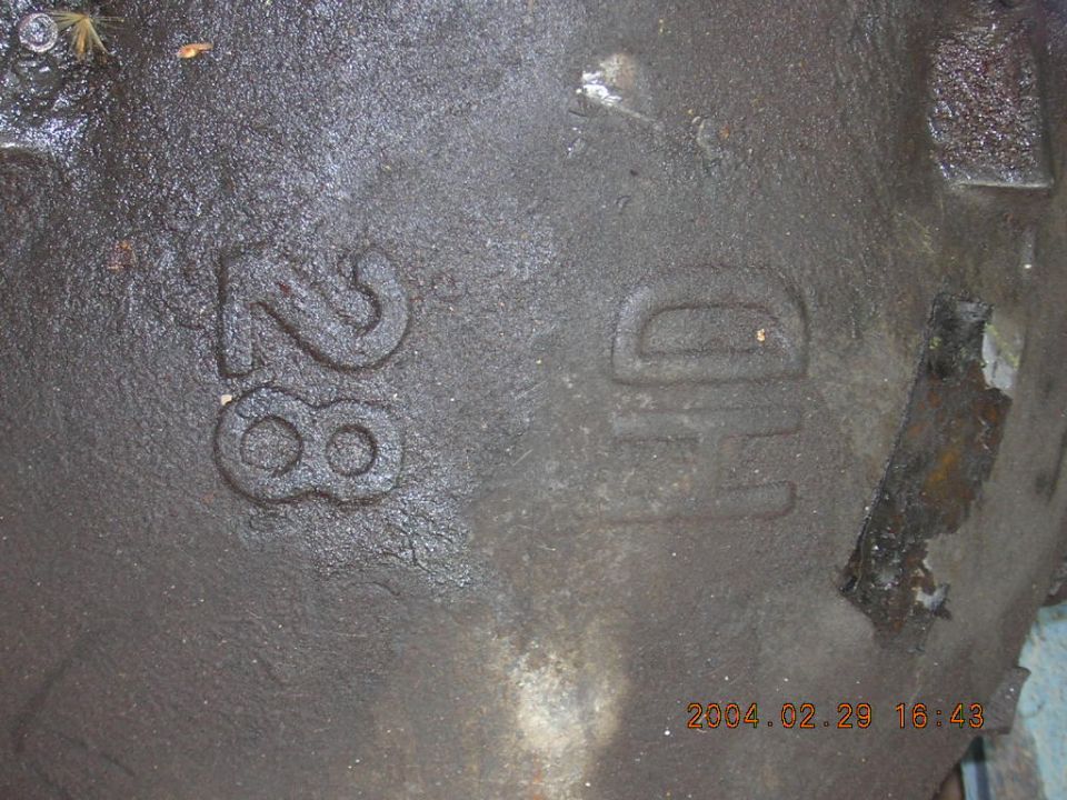 Close-up of a cast iron part with embossed numbers '28' and 'HD'