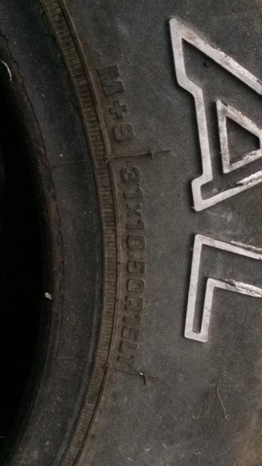 Close-up of a tire sidewall with markings M+S and 31X10.50R15LT.
