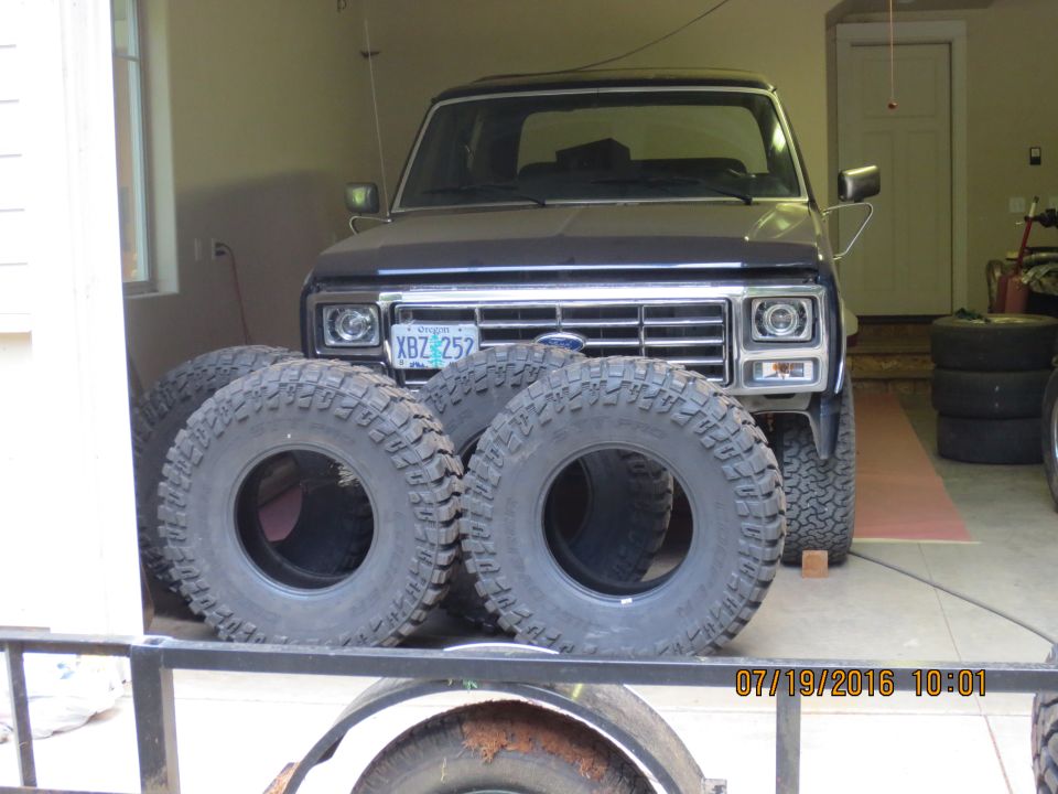 1986 Ford Bronco in garage with off-road tires