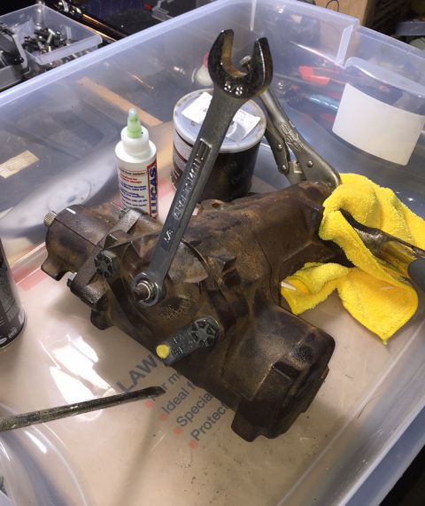 1978 Ford Bronco - A rusty power steering gearbox is shown with a wrench and a yellow cloth. A bottle of Lucas assembly lube is also visible.