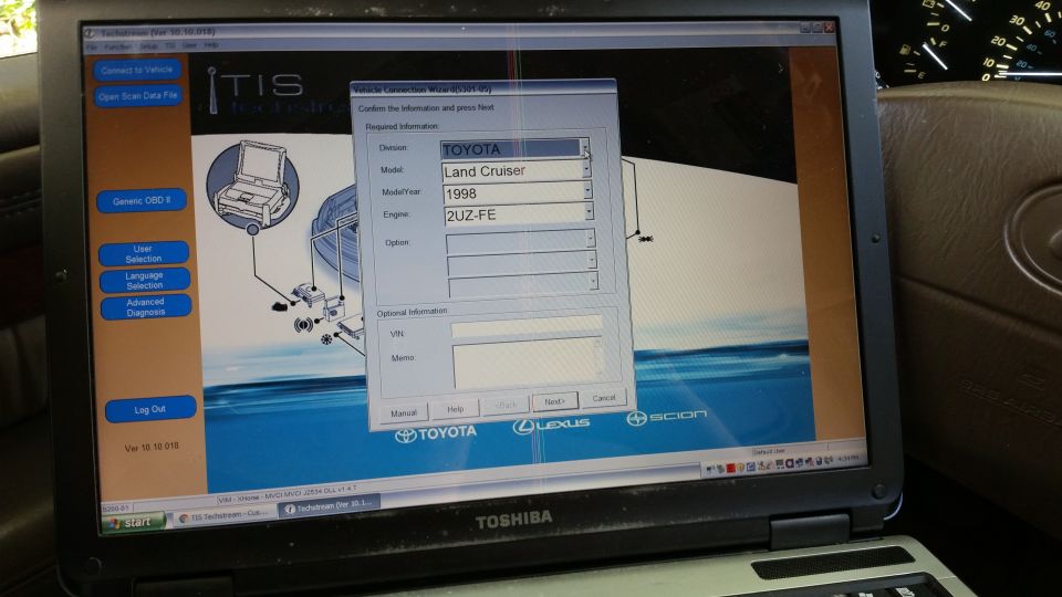 Laptop screen showing Toyota Techstream software with vehicle connection wizard for a 1998 Toyota Land Cruiser.