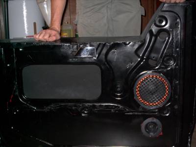 1978 Ford Bronco - The interior of a vehicle door panel is shown, revealing its internal components and construction.