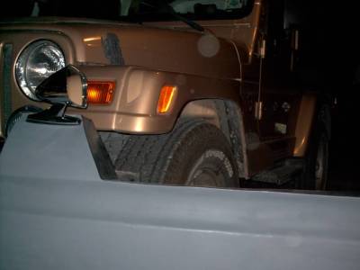 1978 Ford Bronco - Front view of a Jeep Wrangler, partially obscured by a gray bumper.