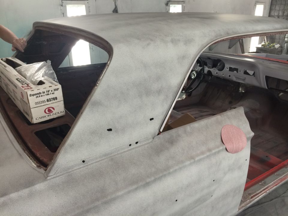 1964 Ford Fairlane interior and roof being prepped for paint, showing dashboard, steering wheel, and primer