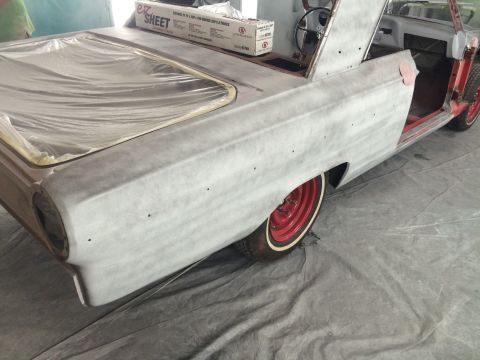 1964 Ford Fairlane - This car is in a workshop, covered in primer and plastic sheeting, awaiting restoration.