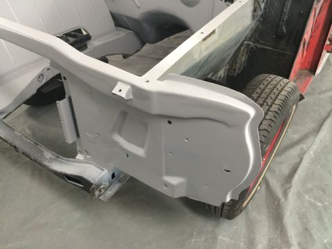 1964 Ford Fairlane - Close-up of a car's frame and a tire during restoration.