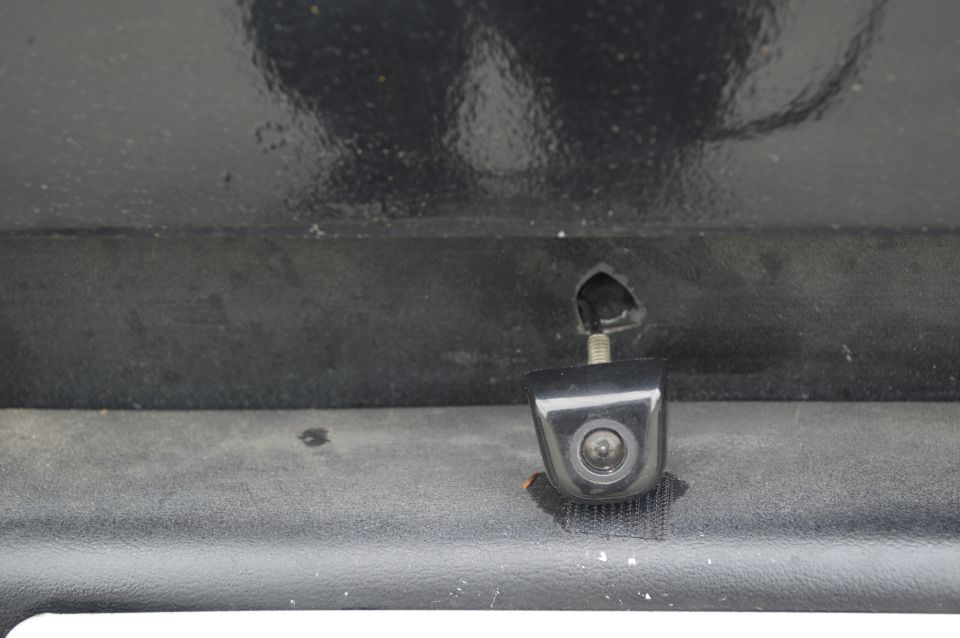 backup camera mounted on black textured surface