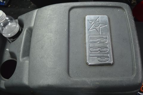 1992 Ford Bronco - Interior view of a vehicle's center console, showing a cup holder and an RBP emblem.