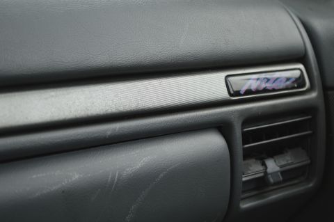 1992 Ford Bronco - Close-up of the dashboard interior, showing a decorative trim piece with lettering.