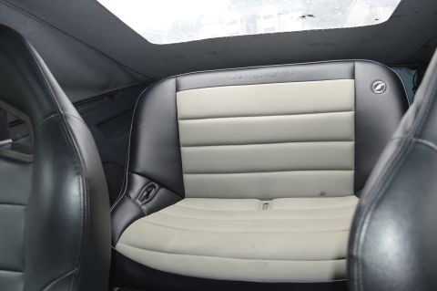 1992 Ford Bronco - Rear interior view of a 1992 Ford Bronco, highlighting the seats and overhead sunroof.