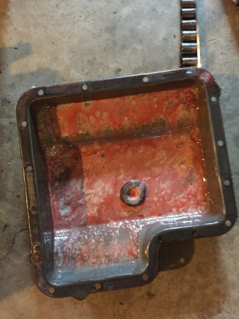 1989 Ford Bronco - this is the transmission pan after i drained the fluid and dropped it. note the odd white, milky, clumpy substance in the bottom of the pan…