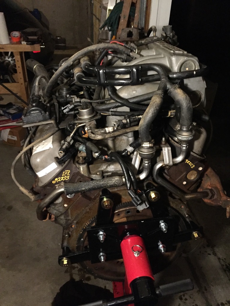 the rear of the engine.  i posted this picture mainly to show the smog hoses (TAB, TAD, Thermactor hoses, whatever you want to call them).  my bronco has different hoses/pipes, and they are not hooked up properly (i have no TAB or TAD valves, the pipe in the exhaust is just directly connected to the pipes in the manifolds).  but on my bronco, the pipes from the exhaust manifolds connect up behind the motor and one pipe runs to where the TAB or TAD should be on the back of the motor.  not sure if this is right or what.  maybe its because this engine was in an E350 van?  maybe its because its a newer year engine.  maybe its supposed to be like this on my bronco?
