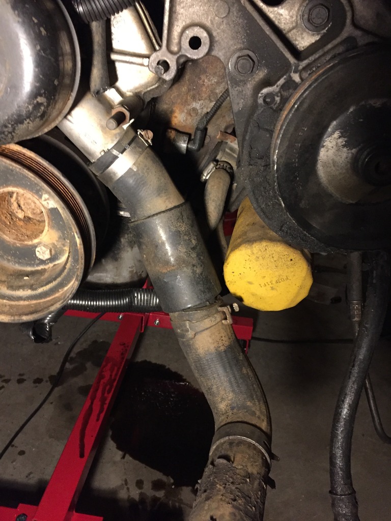 here you can see the oil cooler built into the lower radiator hose.  i will probably remove that since i already have a brand new lower hose without the cooler.  also note how clean and new the water pump looks.