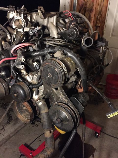 1989 Ford Bronco - here's the front of the motor. since the motor was from an e-van, it has a saginaw power steering pump! score!