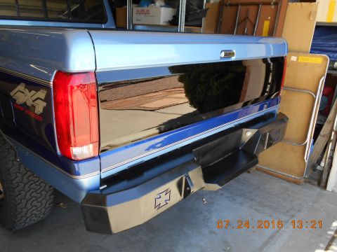 1996 Ford F-250 - Rear view of a blue pickup truck with a custom bumper and 4x4 decal.