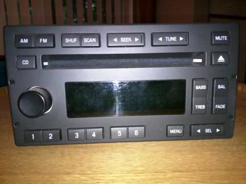 2007 Ford Crown Victoria - A car radio with a digital display and various control buttons is shown.