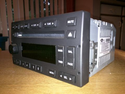 2007 Ford Crown Victoria - Car stereo unit with visible buttons and a label indicating it was manufactured in February 2007.