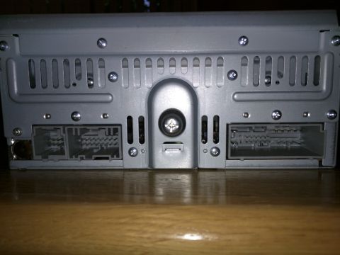 2007 Ford Crown Victoria - The rear of a car stereo unit shows two large electrical connectors and ventilation grilles.