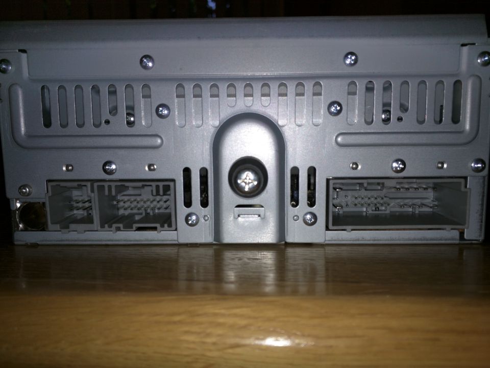 Rear view of car stereo with two multi-pin connectors and ventilation slots