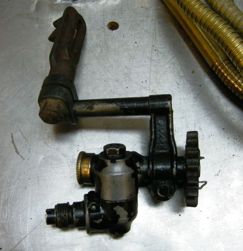 1909 Ford Model T - Close-up of an old automotive part, possibly a fuel pump or carburetor component.